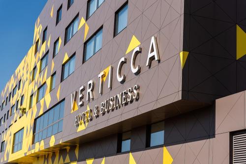 a building with a sign on the side of it at Hotel Verticca in Santa Cruz Tecamac