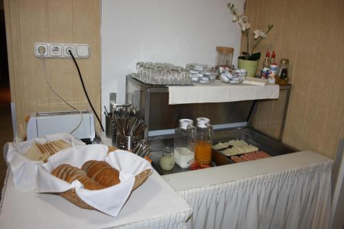 a kitchen with a counter with some bread on it at Polus Pension in Sopron