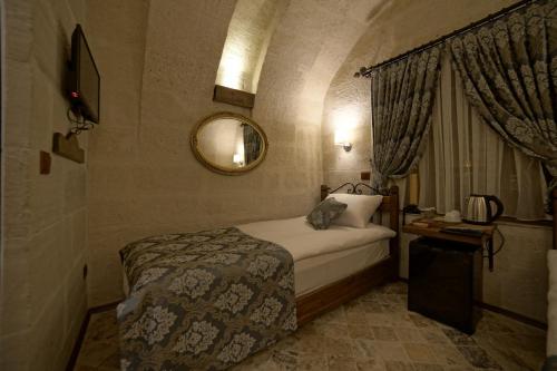 Ένα ή περισσότερα κρεβάτια σε δωμάτιο στο Arte Cave Hotel