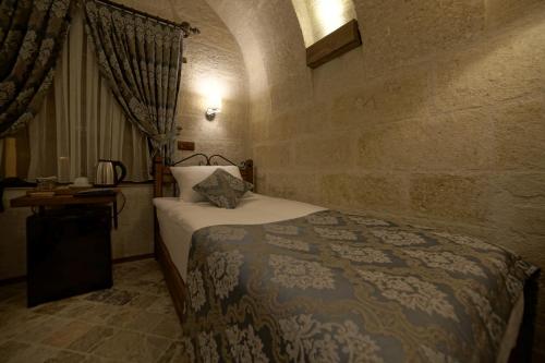 Ένα ή περισσότερα κρεβάτια σε δωμάτιο στο Arte Cave Hotel