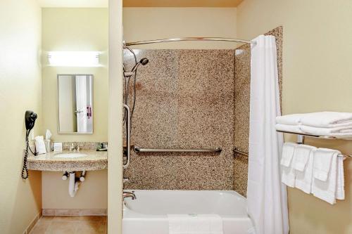 a bathroom with a shower and a sink at Sleep Inn & Suites Tyler South in Tyler