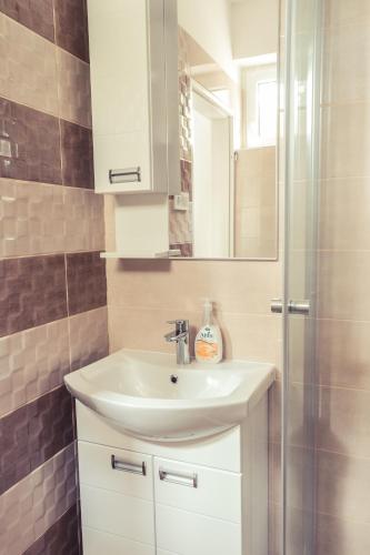 a bathroom with a sink and a shower at Sekli Panzió in Balatonlelle