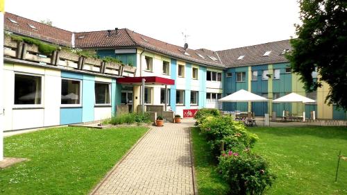 a building with blue and white with a courtyard at Jugendherberge Göttingen in Göttingen