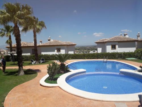 a swimming pool in front of a house at Quickcasaspain sl in Rojales