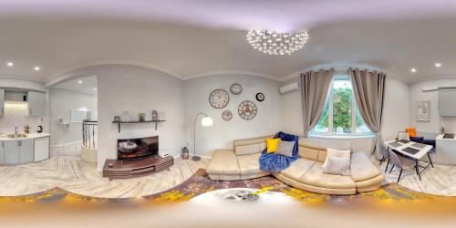 a living room with a couch and a fireplace at The Olive Green House in Burgas City