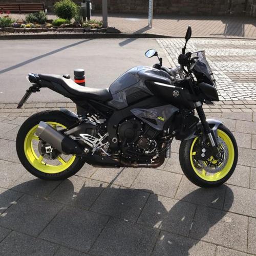 a black motorcycle parked on the side of the street at mosel ferienwohnung in Zell an der Mosel