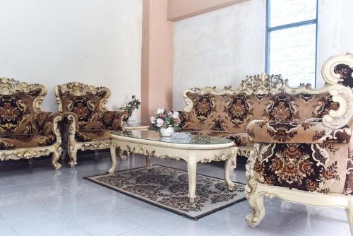 a room with several chairs and a table and a couch at RedDoorz Plus @ Tirta Kencana Hotel in Ambon