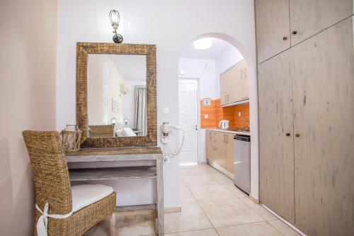 a bathroom with a sink and a mirror at Yianna Studios in Faliraki