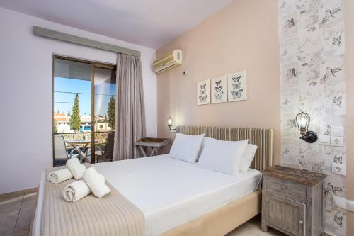 a bedroom with a bed and a balcony at Yianna Studios in Faliraki