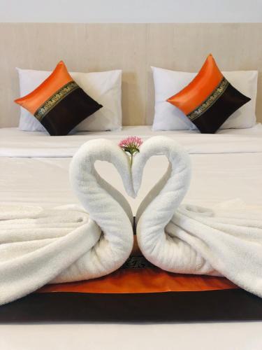 two swans making a heart on a bed at Chiangmun Boutique in Chiang Mai