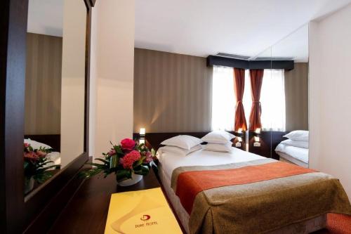 a hotel room with a bed and a mirror at Hotel Duke Armeneasca - Ex Tempo in Bucharest