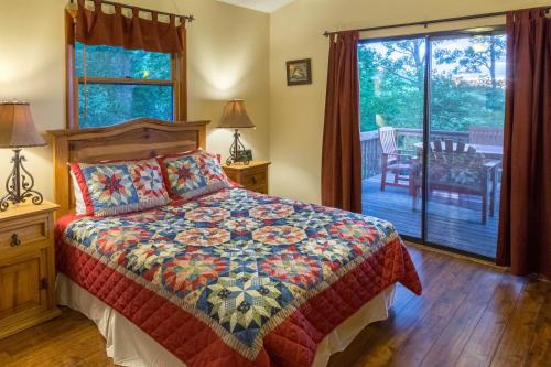a bedroom with a bed and a sliding glass door at 3 Bed 3 Bath Vacation home in Sylva in Sylva