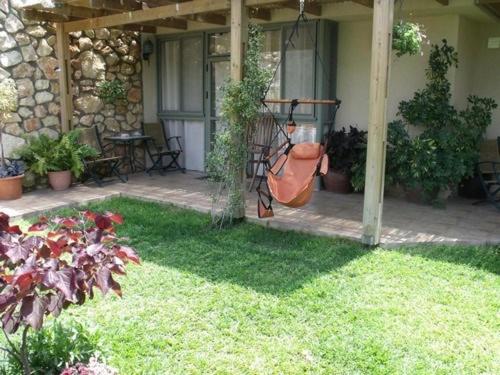 a patio with a swing in the yard at צימורן in Moran
