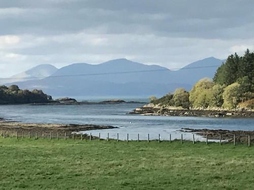 a view of a river with mountains in the background at The West Highland Way Campsite & Campervan Accommodation in Milngavie