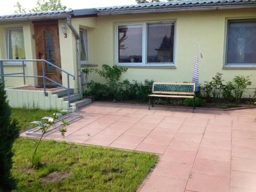 a bench sitting in front of a house at Haus Amira in Gager