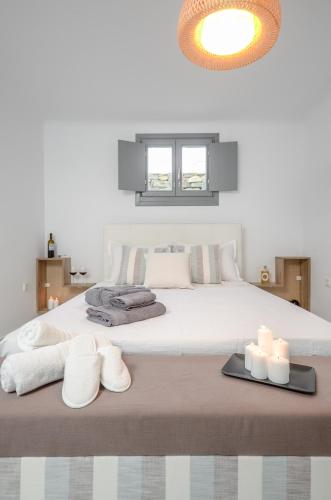 a bedroom with a large bed with towels and candles at Villa Tranquillity in Kastraki Naxou