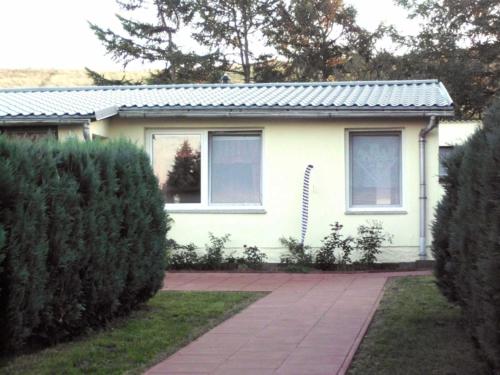 a white house with a walkway in front of it at Haus Amira in Gager