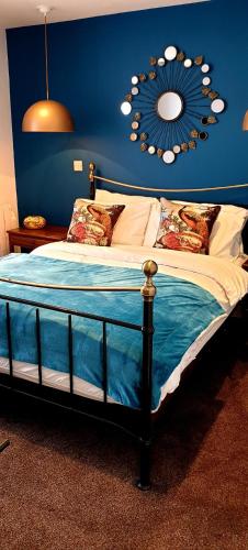 a bedroom with a bed with a mirror on the wall at 20 Market Place Coleford in Coleford