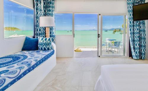 a bedroom with a bed and a view of the ocean at So KohKoon Beach Resort in Bang Rak Beach