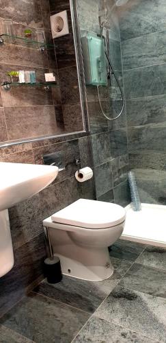 a bathroom with a toilet and a sink and a tub at 20 Market Place Coleford in Coleford