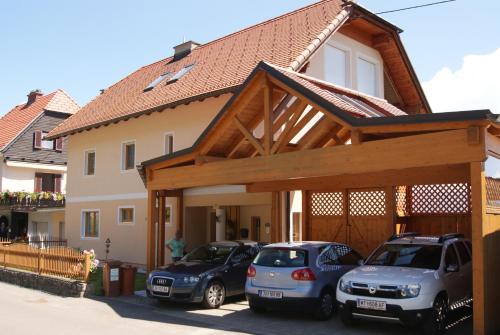 two cars parked in front of a house at Privatzimmer Mitterbacher in Fohnsdorf