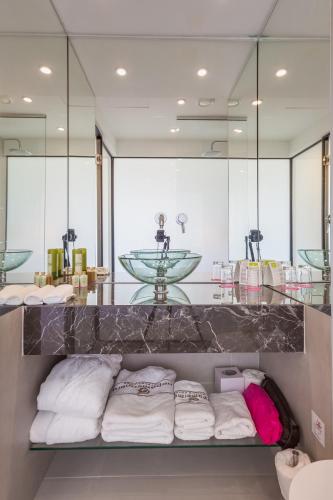 a bathroom with a counter with a row of towels at Napa Mermaid Hotel & Suites in Ayia Napa