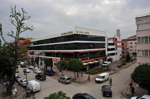 a large building with cars parked in a parking lot at Royal Hotel Inegol in Inegol