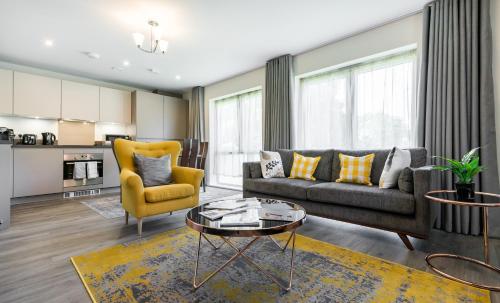 a living room with a couch and a table at Fortified Luxury Apartment in Chatham