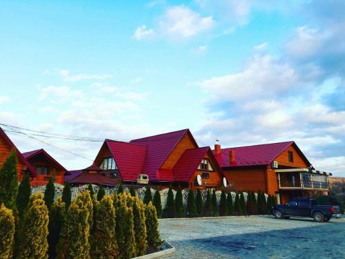 a house with a car parked in front of it at GorodOk in Migovo