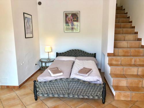 a bed in a room with a staircase at Residenza Ai Ronchi 1 2 6 in Maccagno con Pino e Veddasca