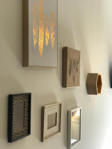 a wall with different types of art on it at Ô 36 Rempart Sud B&B in Aigues-Mortes