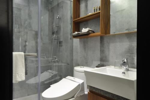 a bathroom with a toilet and a sink and a shower at Tsang Kuo Resort in Wujie