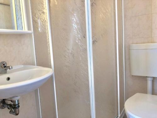 a bathroom with a shower with a sink and a toilet at Residenza Ai Ronchi 1 2 6 in Maccagno con Pino e Veddasca