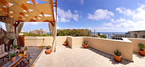 a rooftop patio with a view of the ocean at CENTER Penthouse - MEDIEVAL Town 10'- BEACH 2' in Rhodes Town