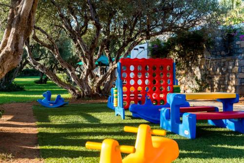 a playground with colorful play equipment in a park at Elounda Beach Hotel & Villas, a Member of the Leading Hotels of the World in Elounda