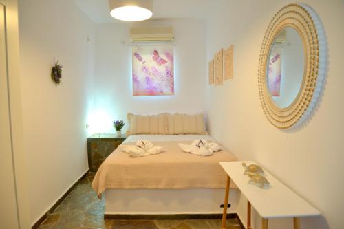 a small bedroom with a bed with a mirror at Traditional Villa Relax in Zefiría