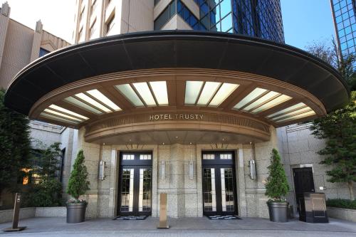 a building with a hotel flush sign in front of it at Hotel Trusty Tokyo Bayside in Tokyo