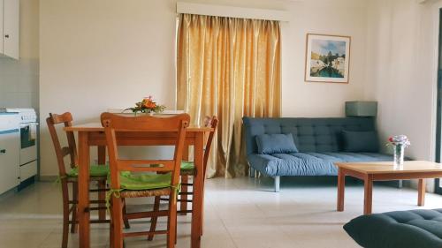 a living room with a table and chairs and a couch at Milounapa in Ayia Napa