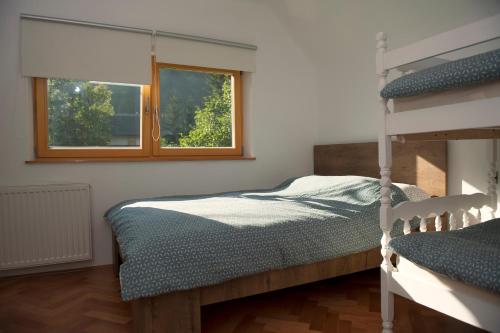 a bedroom with a bunk bed and a window at Apartment Polane in Blejska Dobrava