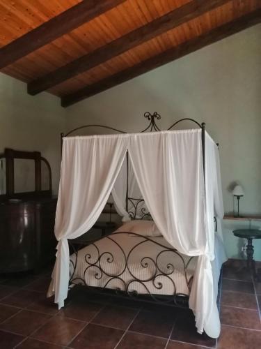 a bedroom with a bed with a canopy at Il casale Falagario Stacca in Altamura
