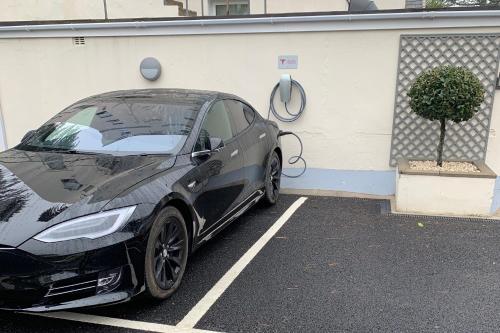 a black car parked in a parking lot at The Park Hotel in Tenby