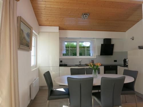 a kitchen and dining room with a table and chairs at Jade B&B in Bouveret