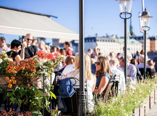 a group of people sitting at an outdoor event at Lydmar Hotel in Stockholm