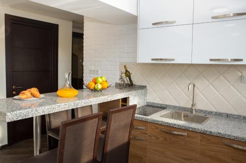 a kitchen with a counter with a bowl of fruit on it at Boutique Hotel in Tbilisi City
