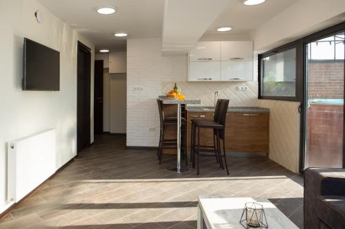 a kitchen and living room with a table and chairs at Boutique Hotel in Tbilisi City
