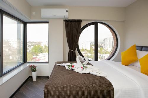 a bedroom with a large bed with a large window at Boutique Hotel in Tbilisi City