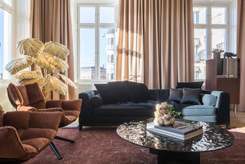 a living room with two couches and a coffee table at Lydmar Hotel in Stockholm