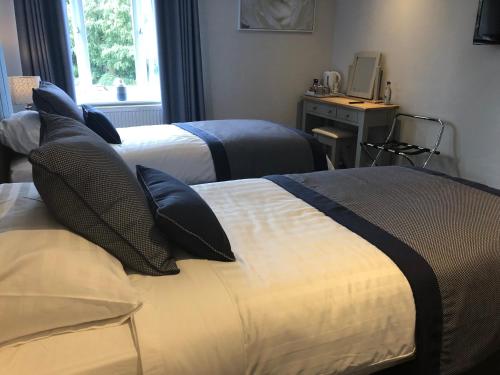 A bed or beds in a room at Kinderton House Hotel 