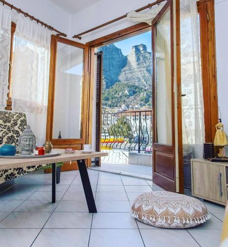 a room with a table and a view of a mountain at The balcony of Meteora the center of kalabaka in Kalabaka