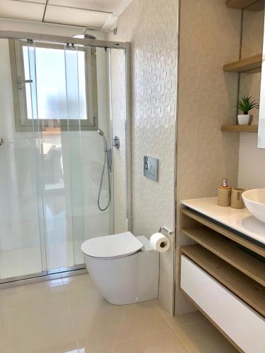 a bathroom with a shower and a toilet and a sink at Luxury Villa4you in Los Alcázares